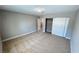 Bedroom features neutral walls, plush carpet and large closet with sliding doors at 2428 Greens Ave, Henderson, NV 89014