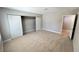 Bedroom features neutral walls, plush carpet and large closet with sliding doors at 2428 Greens Ave, Henderson, NV 89014