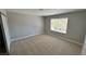 Bright bedroom with neutral carpet and a large window providing plenty of natural light at 2428 Greens Ave, Henderson, NV 89014