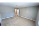 Bedroom features neutral walls, plush carpet and an open doorway to the bathroom at 2428 Greens Ave, Henderson, NV 89014