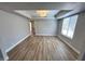 Bright bedroom with durable wood floors, modern lighting, and a large window at 2428 Greens Ave, Henderson, NV 89014