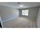 Bright bedroom with plush carpet, neutral walls and natural light from a window at 2428 Greens Ave, Henderson, NV 89014