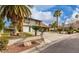 Beautiful two-story house with brick accents and mature landscaping, including well-manicured lawn and palm trees at 2428 Greens Ave, Henderson, NV 89014