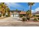 Charming two-story home with a two-car garage, complemented by mature palm trees and manicured landscaping at 2428 Greens Ave, Henderson, NV 89014
