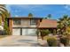 Beautiful two-story home with brick accents, mature palm trees, and well-manicured landscaping at 2428 Greens Ave, Henderson, NV 89014