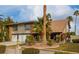 Two-story house with brick accents, two-car garage, mature palms and a circular landscaped yard at 2428 Greens Ave, Henderson, NV 89014