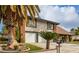 Charming two-story home with a two-car garage, well-kept lawn, and mature palm trees in a desirable location at 2428 Greens Ave, Henderson, NV 89014