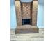 Close-up of the red brick fireplace, a cozy focal point in the living space at 2428 Greens Ave, Henderson, NV 89014