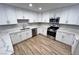 Clean kitchen featuring stainless steel appliances, quartz countertops, and white cabinets at 2428 Greens Ave, Henderson, NV 89014