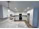 Bright kitchen features white cabinets, stainless steel appliances, and quartz countertops at 2428 Greens Ave, Henderson, NV 89014