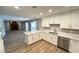 Well-lit kitchen with white cabinets and quartz countertops open to the living area at 2428 Greens Ave, Henderson, NV 89014