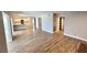 Open floor plan shows living area connected to the kitchen with wood laminate flooring at 2428 Greens Ave, Henderson, NV 89014