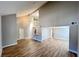 Bright living room featuring wood floors, high ceilings, and stairs leading to a second level at 2428 Greens Ave, Henderson, NV 89014