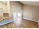 Open-concept living room featuring stairs, wood floors, and neutral paint throughout the home at 2428 Greens Ave, Henderson, NV 89014