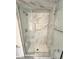 Modern bathroom with a glass-enclosed shower featuring marble tiling and a rainfall showerhead at 2428 Greens Ave, Henderson, NV 89014