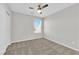 Comfortable bedroom with carpet flooring and a window providing natural light and neighborhood views at 2449 Padulle Pl, Henderson, NV 89044