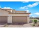 Inviting home exterior features a multi-car garage, desert landscaping, and a sunny sky at 2449 Padulle Pl, Henderson, NV 89044