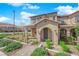 Inviting home facade featuring a covered entrance, manicured landscaping, and a well-maintained walkway at 2449 Padulle Pl, Henderson, NV 89044