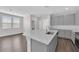 Bright kitchen featuring an island with seating, stainless steel appliances, and an open concept design at 2449 Padulle Pl, Henderson, NV 89044