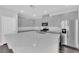 Elegant kitchen featuring gray cabinets, a spacious island, and stainless steel appliances for modern living at 2449 Padulle Pl, Henderson, NV 89044