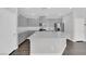 Well-lit kitchen showcasing gray cabinetry, a central island, stainless steel appliances, and modern finishes at 2449 Padulle Pl, Henderson, NV 89044