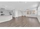 Spacious living area with hardwood floors, a kitchen, and ample natural light, creating a comfortable ambiance at 2449 Padulle Pl, Henderson, NV 89044