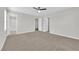 Spacious main bedroom with neutral carpet, ceiling fan and walk-in closet at 2449 Padulle Pl, Henderson, NV 89044