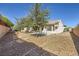 Well-maintained backyard features gravel and mature shade trees at 2557 Terrytown Ave, Henderson, NV 89052