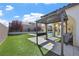 Outdoor living with a built-in BBQ area, pergola, lush lawn, and a sparkling pool at 2804 Candelaria Dr, Henderson, NV 89074
