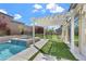 Inviting backyard featuring a pergola, spa, and lush green turf at 2804 Candelaria Dr, Henderson, NV 89074