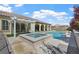 Gorgeous backyard oasis with pool, spa, covered patio, and lush landscaping at 2804 Candelaria Dr, Henderson, NV 89074