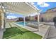 Beautiful backyard showcasing a pool, spa, manicured landscaping, and a shaded pergola at 2804 Candelaria Dr, Henderson, NV 89074