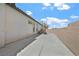 Spacious concrete backyard area featuring a basketball hoop and a high block wall for privacy at 2804 Candelaria Dr, Henderson, NV 89074