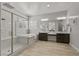 Spacious bathroom featuring a soaking tub, glass shower, and dual sink vanity at 2804 Candelaria Dr, Henderson, NV 89074