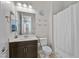 Bright bathroom featuring a modern vanity, white toilet, shower with curtain, and a decorative 'Beach Vibes Only' sign at 2804 Candelaria Dr, Henderson, NV 89074