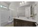 Well-lit bathroom featuring a combination tub/shower, large mirror, and a vanity with ample counter space at 2804 Candelaria Dr, Henderson, NV 89074