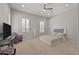 Bright bedroom featuring neutral carpet, plantation shutters, a comfortable chair and a minimalist style bed at 2804 Candelaria Dr, Henderson, NV 89074