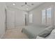 Bright bedroom featuring neutral carpet, plantation shutters, a ceiling fan and a minimalist style bed at 2804 Candelaria Dr, Henderson, NV 89074