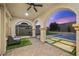 Covered patio with brick flooring, outdoor seating, fan, and views of the pool and backyard at 2804 Candelaria Dr, Henderson, NV 89074