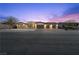 Stunning exterior elevation features desert landscaping, large driveway, and a 3-car garage at 2804 Candelaria Dr, Henderson, NV 89074