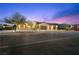 Captivating exterior showcasing well-maintained landscaping and a three-car garage at twilight at 2804 Candelaria Dr, Henderson, NV 89074