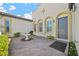 Inviting front entrance with a decorative water fountain, arched windows, and well-maintained landscaping at 2804 Candelaria Dr, Henderson, NV 89074