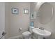 Stylish half bathroom with elegant fixtures, vanity, and decorative wall art at 2804 Candelaria Dr, Henderson, NV 89074