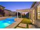 Inviting pool and spa area with pergola, lush artificial turf, and stylish design elements at 2804 Candelaria Dr, Henderson, NV 89074