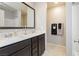 Modern bathroom featuring a double sink vanity with dark cabinets and a large mirror at 2871 Cabrillo Terrace St, Henderson, NV 89044