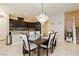 Dining area with views of the kitchen featuring an elegant chandelier and staircase at 2871 Cabrillo Terrace St, Henderson, NV 89044