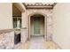 Inviting front entryway with stone details, arched doorframe, and a paved walkway at 2871 Cabrillo Terrace St, Henderson, NV 89044