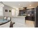 Modern kitchen with granite countertops, stainless steel appliances, and dark cabinets at 2871 Cabrillo Terrace St, Henderson, NV 89044