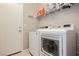 Functional laundry room equipped with modern washer and dryer units and storage shelves at 2871 Cabrillo Terrace St, Henderson, NV 89044
