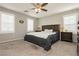 Comfortable main bedroom featuring carpet, ceiling fan, and natural light from the large window at 2871 Cabrillo Terrace St, Henderson, NV 89044